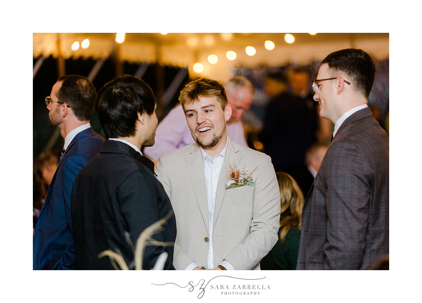 groom talks with guests during Rhode Island wedding reception