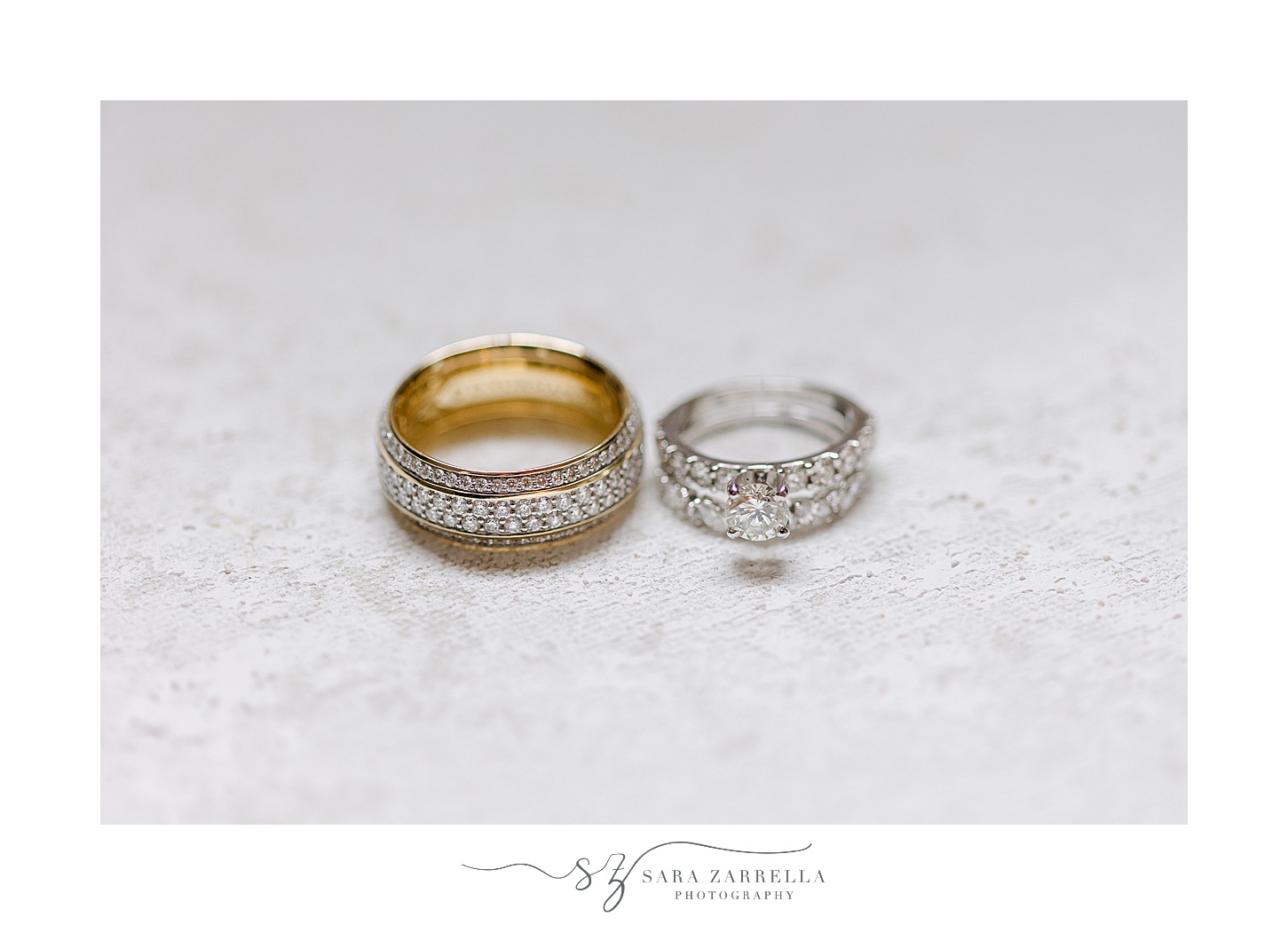 gold and diamond wedding bands rest on marble surface 