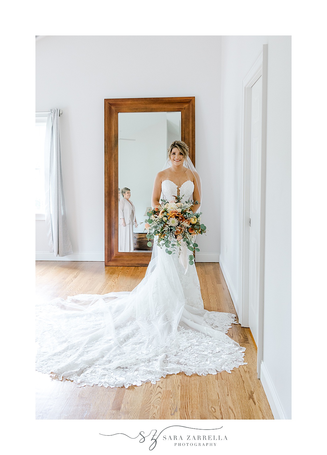 bride poses in front of mirror before Westerly RI wedding day 