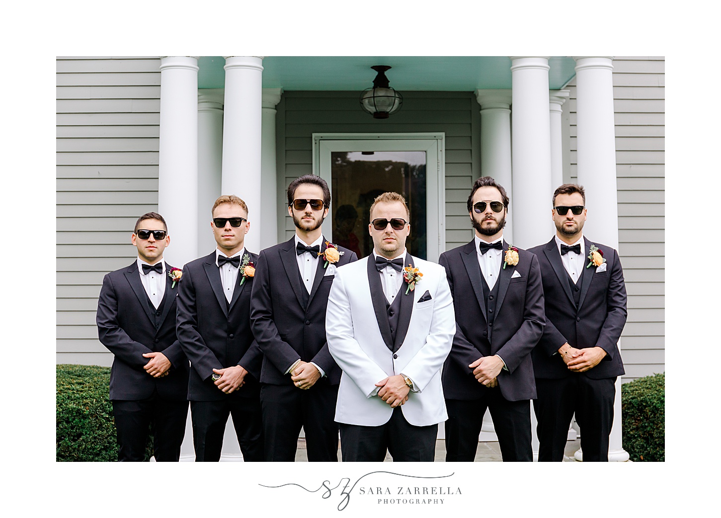 groom and groomsmen pose in front of Westerly RI home