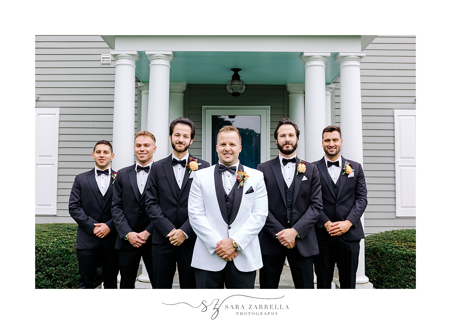 groom pose with groomsmen in front of Westerly RI home