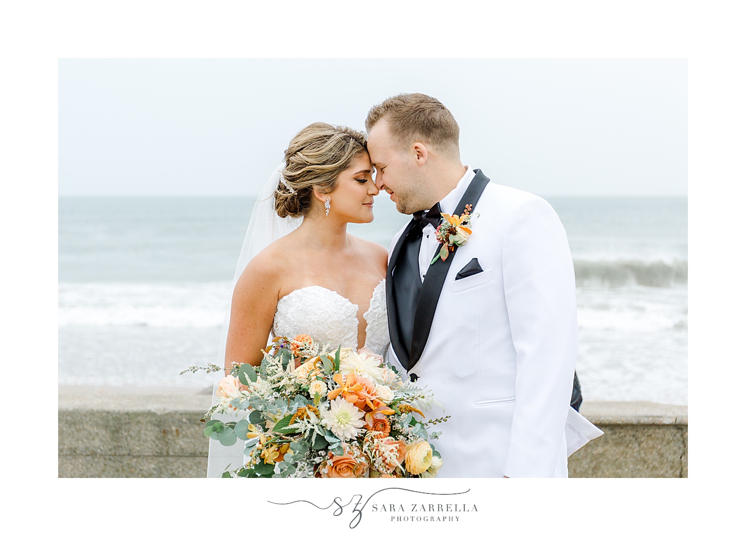 newlyweds lean heads together on beachfront in Westerly RI