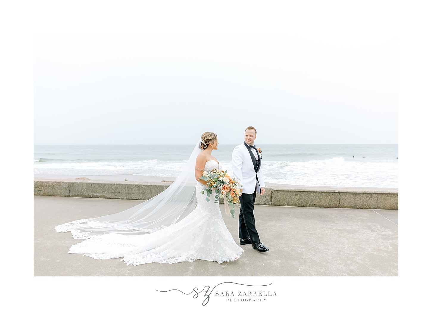 bride and groom walk along beachfront in Westerly RI