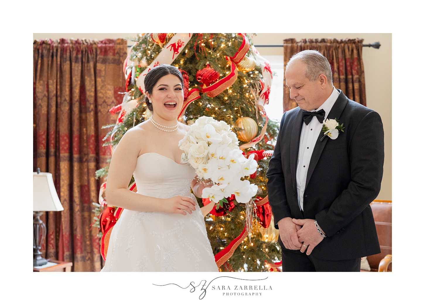 bride and dad laugh during first look by Christmas tree before Ballroom at the Providence G wedding