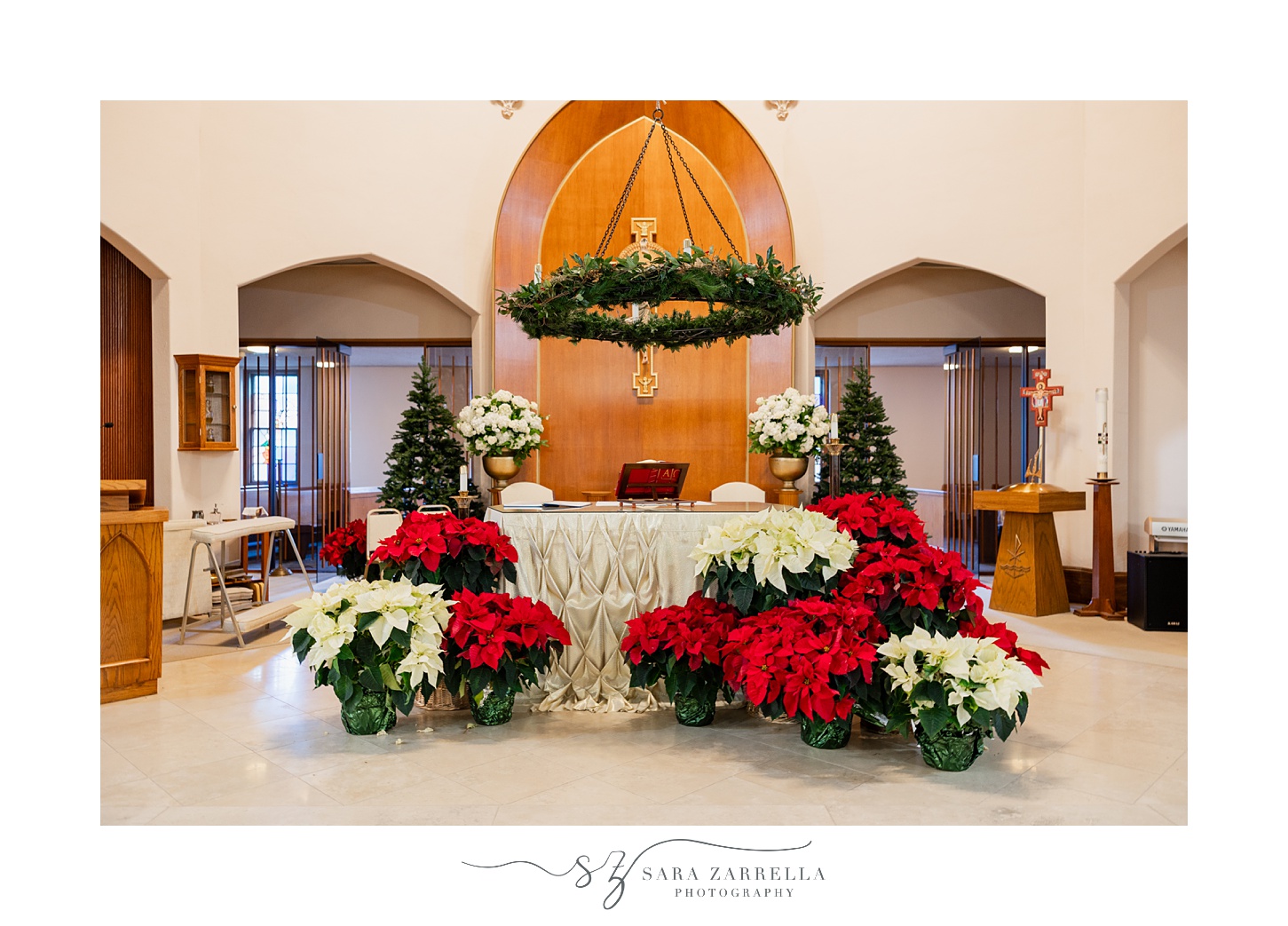 red and white poinsettias around alter at St. Thomas Church in Providence RI