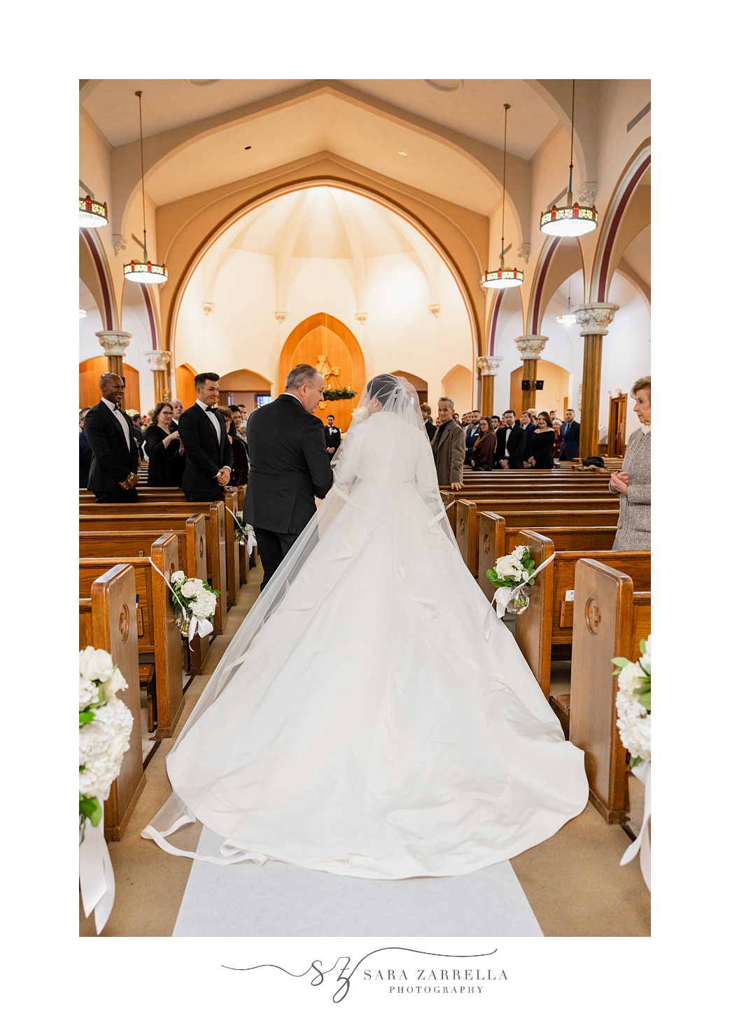 father walks bride down aisle inside St. Thomas Church in Providence RI