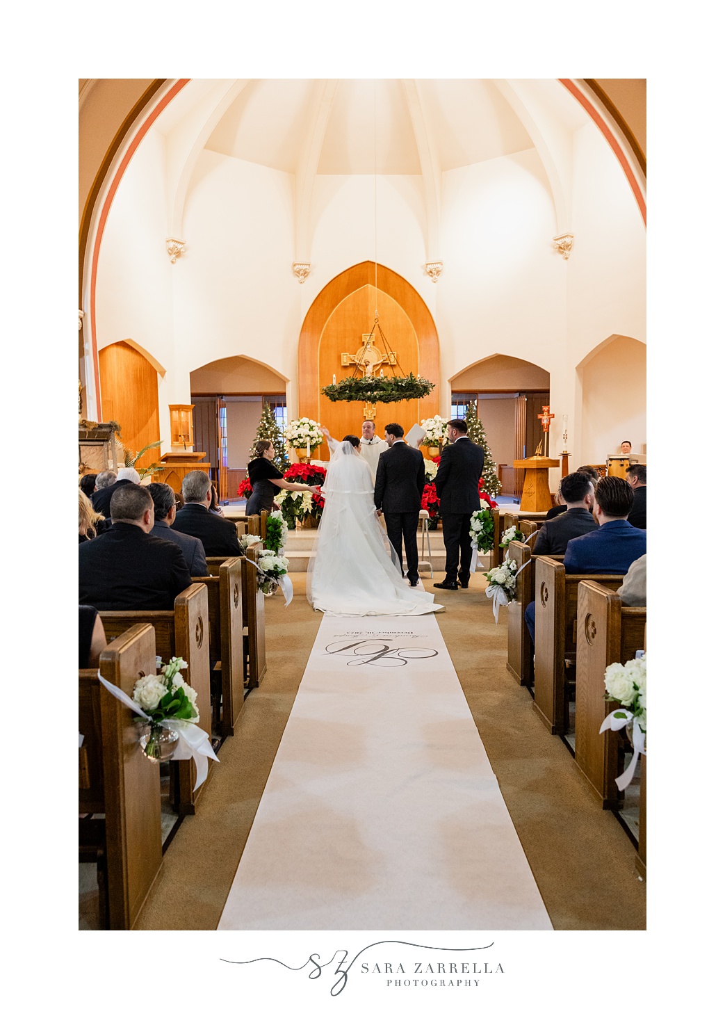 bride and groom stand at alter inside St. Thomas Church in Providence RI