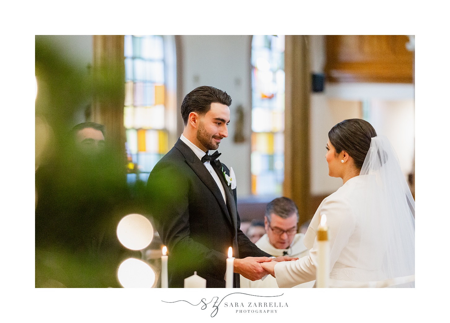 groom smiles at bride during ceremony at St. Thomas Church in Providence RI