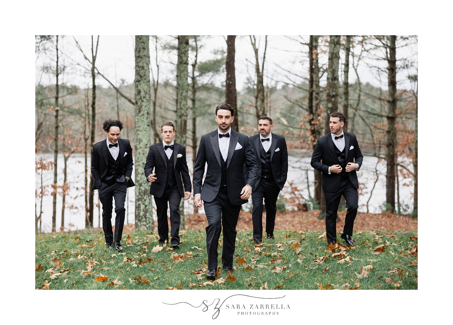 groom walks with groomsmen on fallen leaves in Providence RI