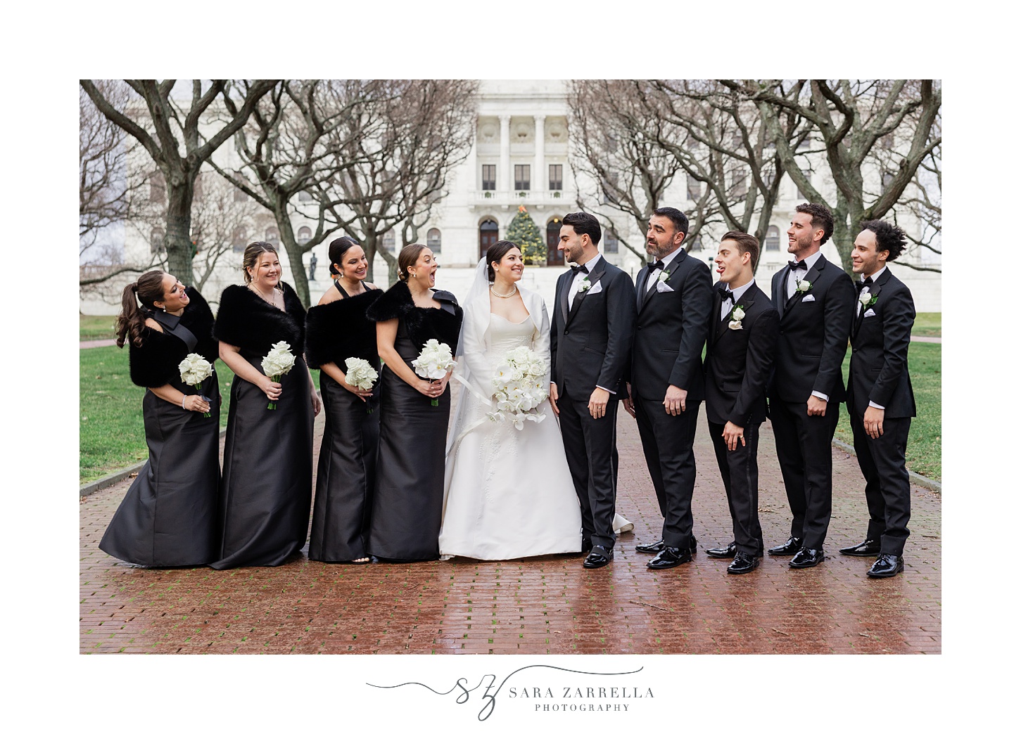 newlyweds smile with bridal party in line around them outside the RI State House