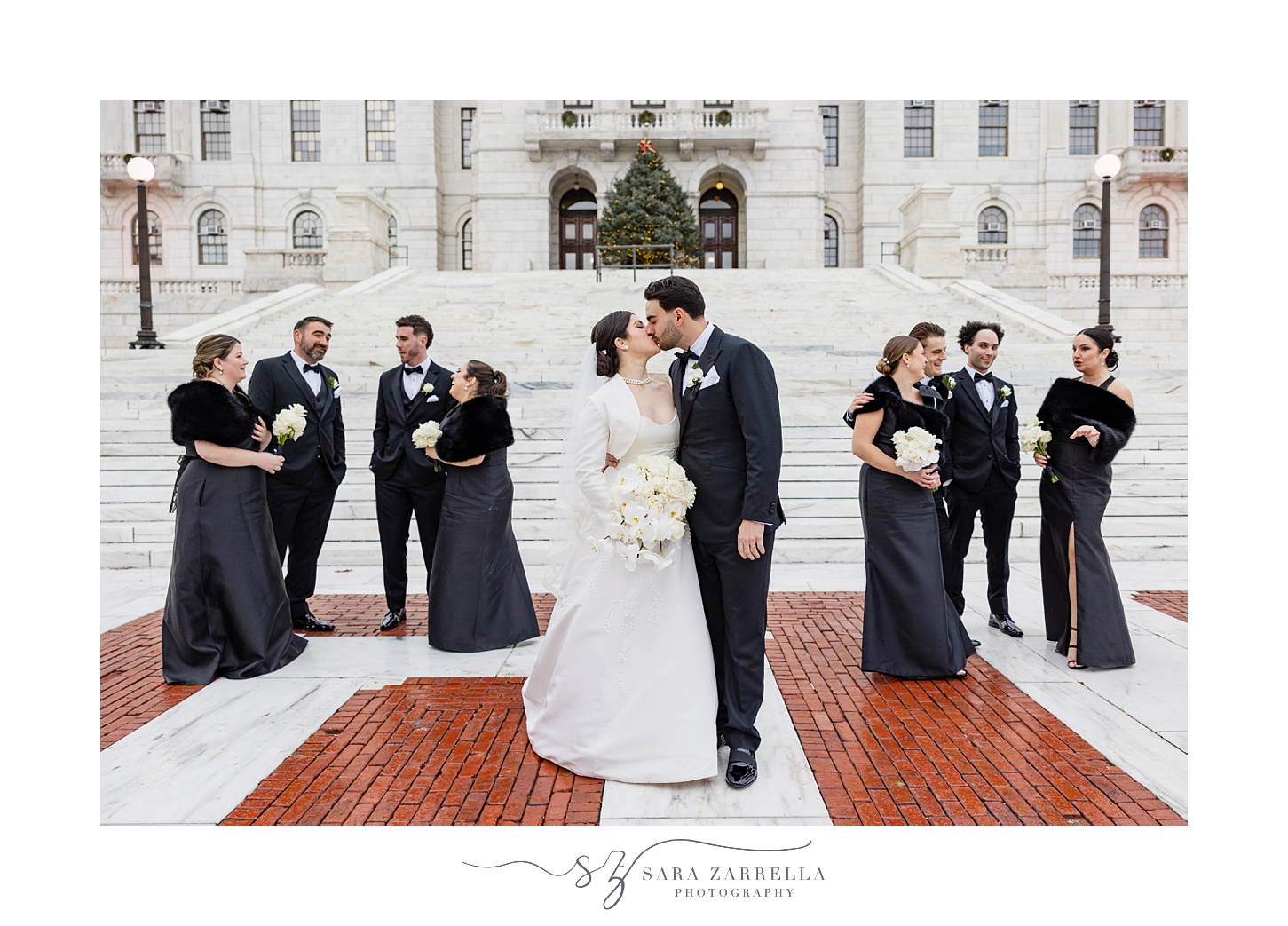 bride and groom kiss in the rain at the RI State House