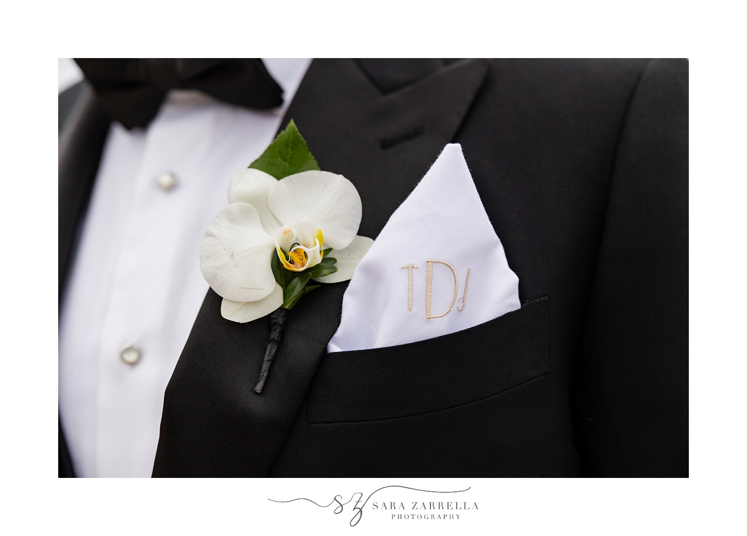 groom's white orchid boutonnière with pocket square 