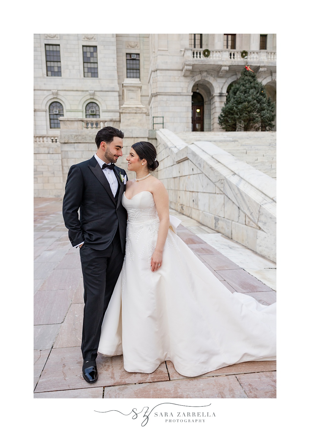 newlyweds hug on brick patio of the RI State House