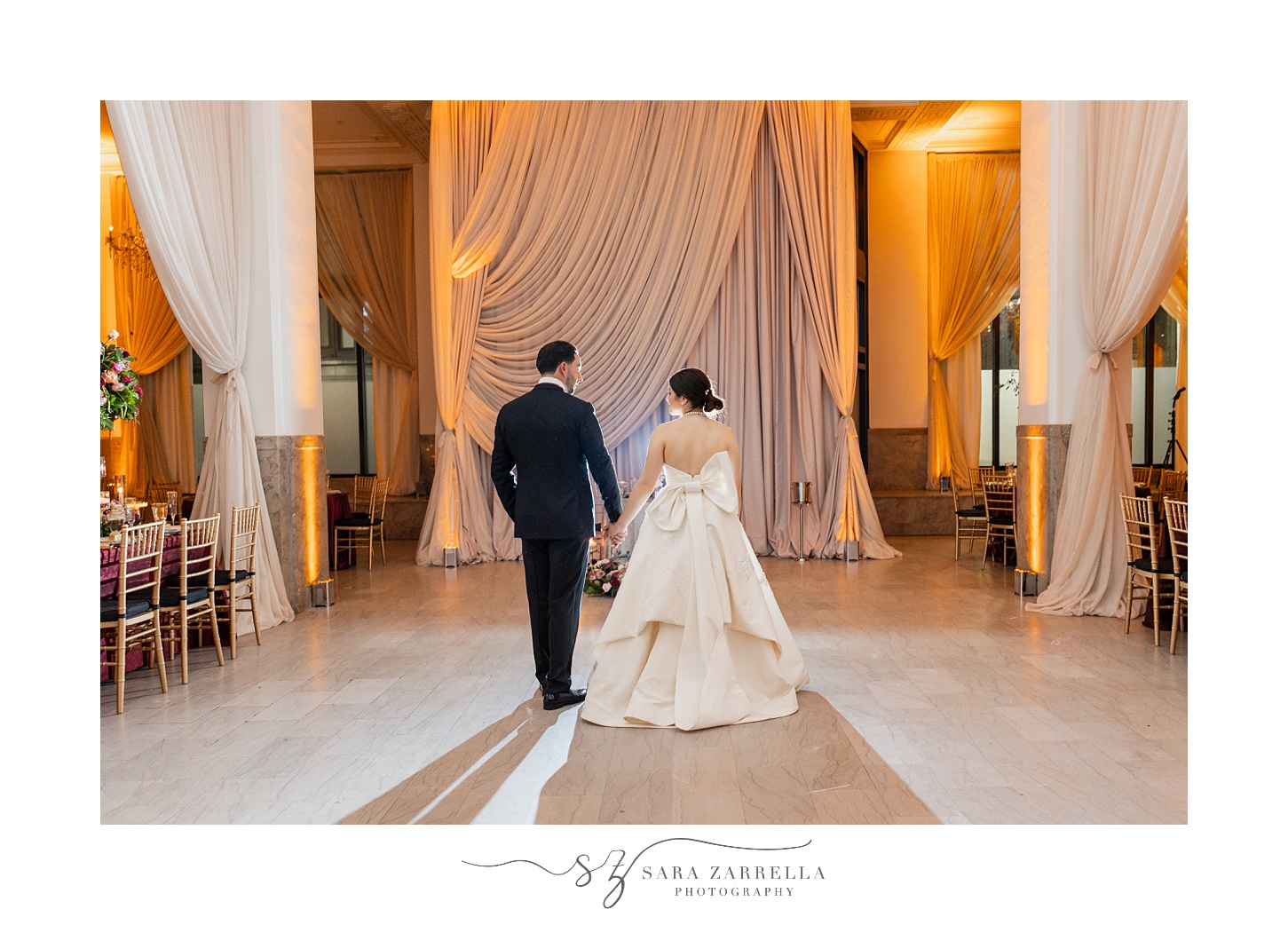 bride and groom walk towards reception at Ballroom at the Providence G