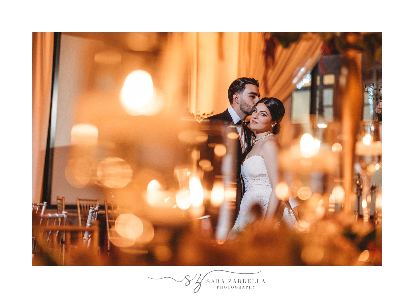 groom leans to kiss bride's forehead in background of photo 