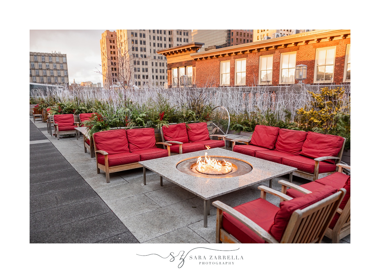 red cushioned chairs around fire pit at the Providence G