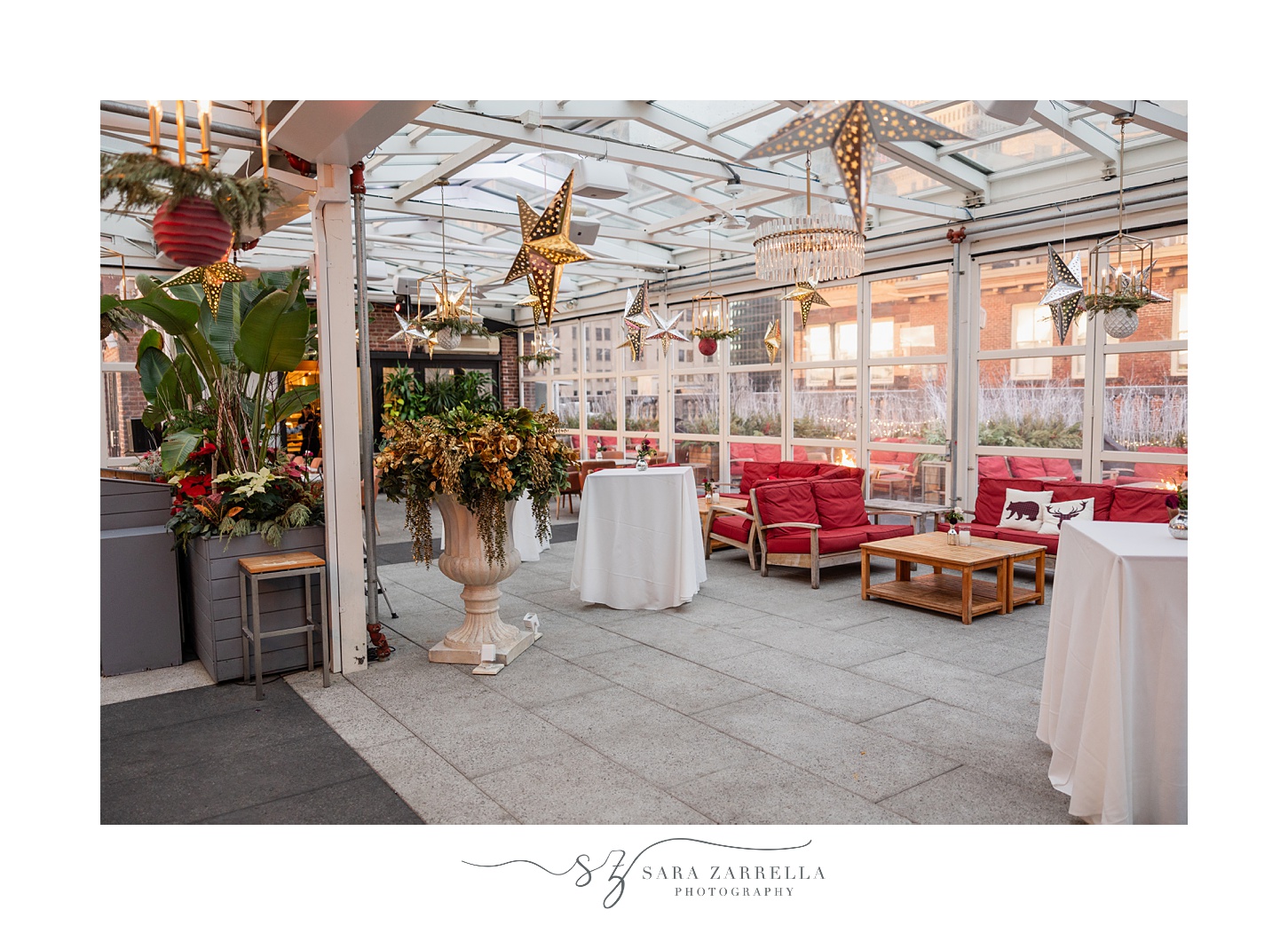 outdoor seating with red chairs and hanging gold stars at the Providence G