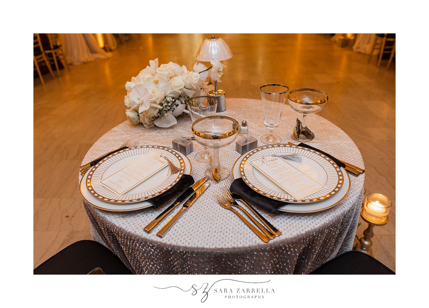 sweetheart table with white and gold plates at ballroom at the Providence G