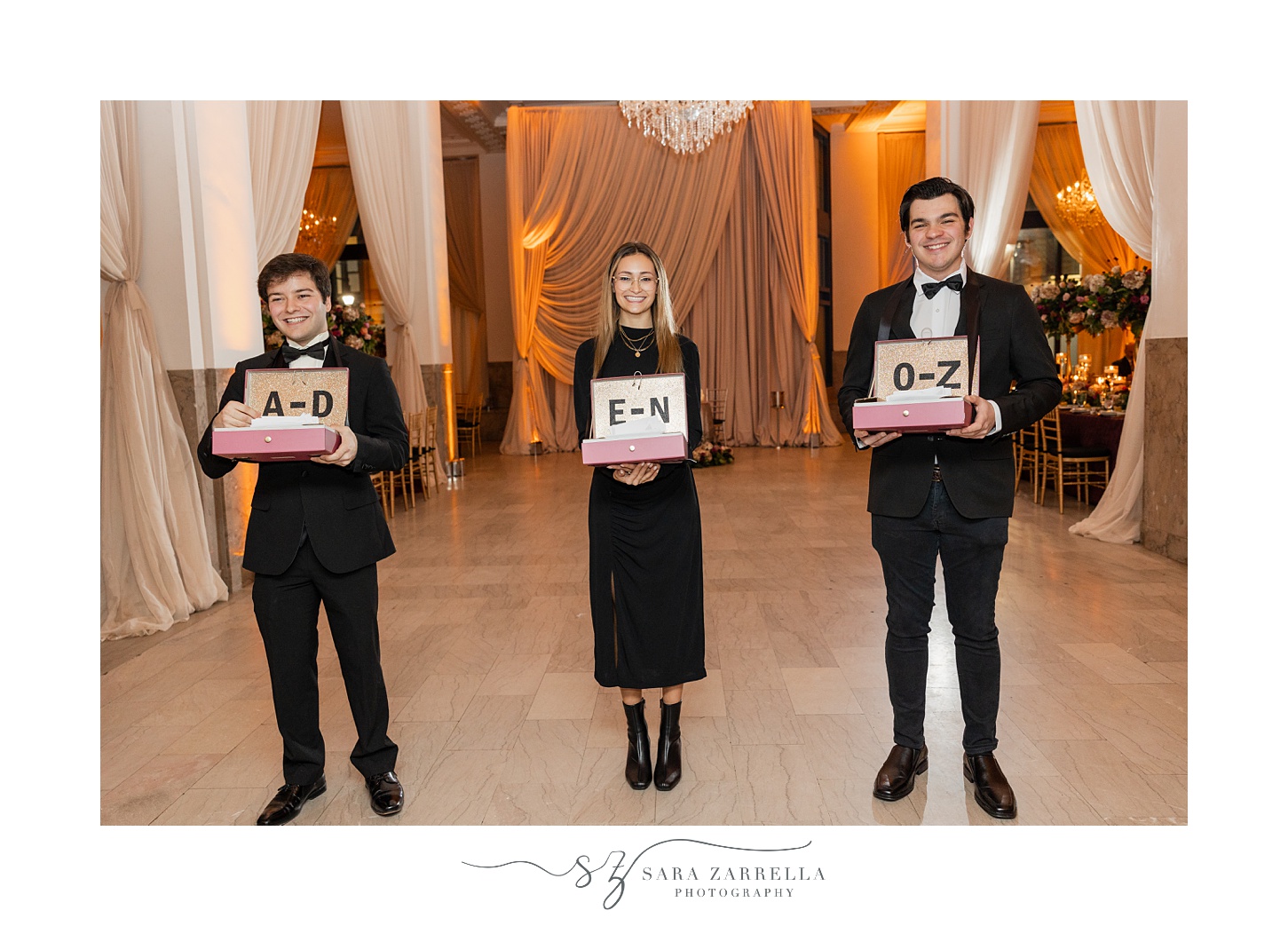 planners hand escort cards out during reception at the ballroom at the Providence G