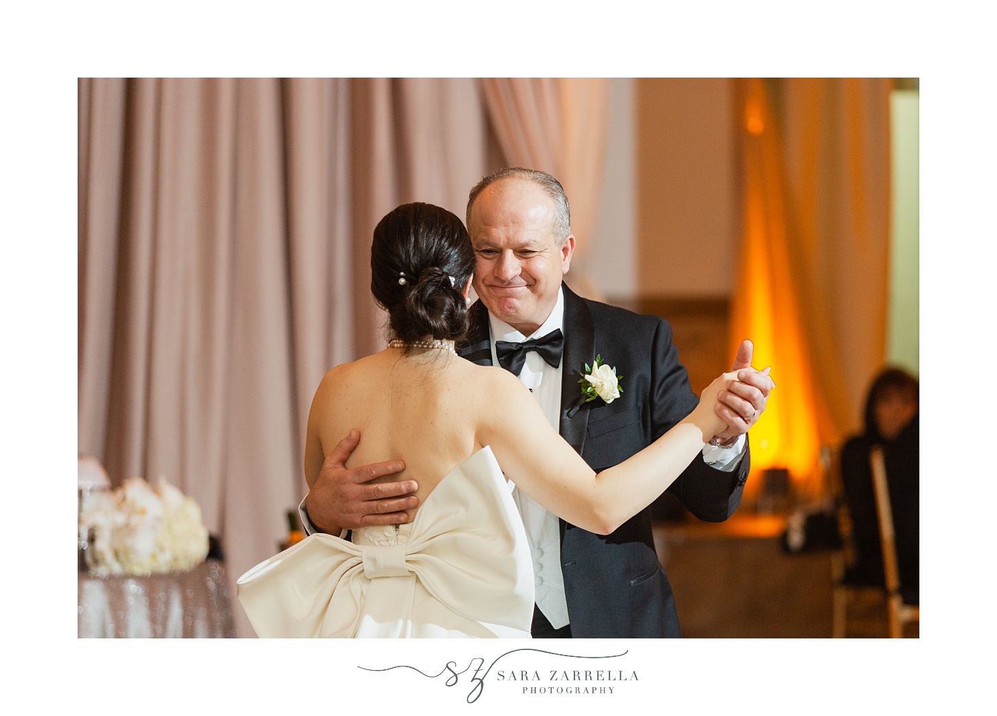 dad smiles dancing with bride on her wedding day 