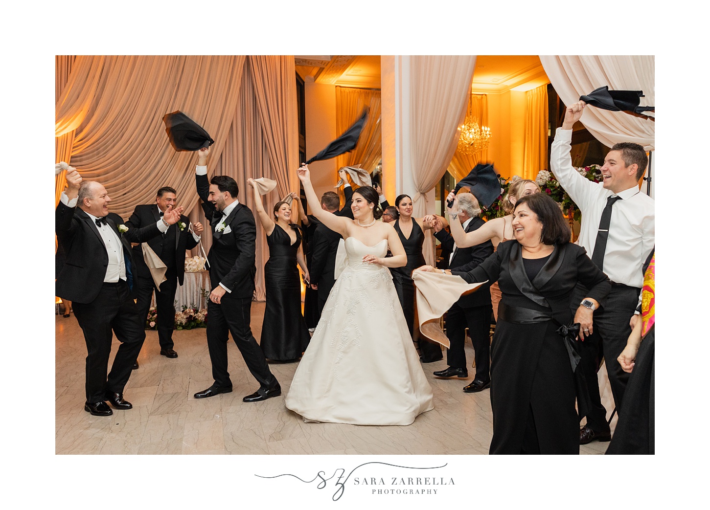 newlyweds twirl napkins with family on dance floor