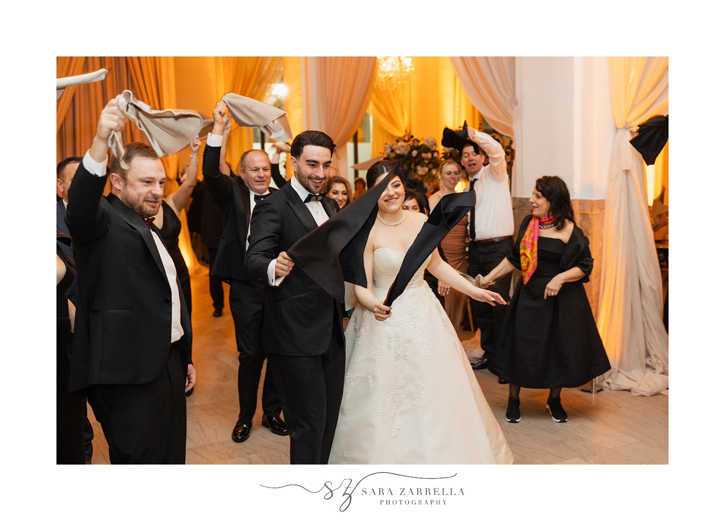 bride and room twirl napkins during wedding reception 