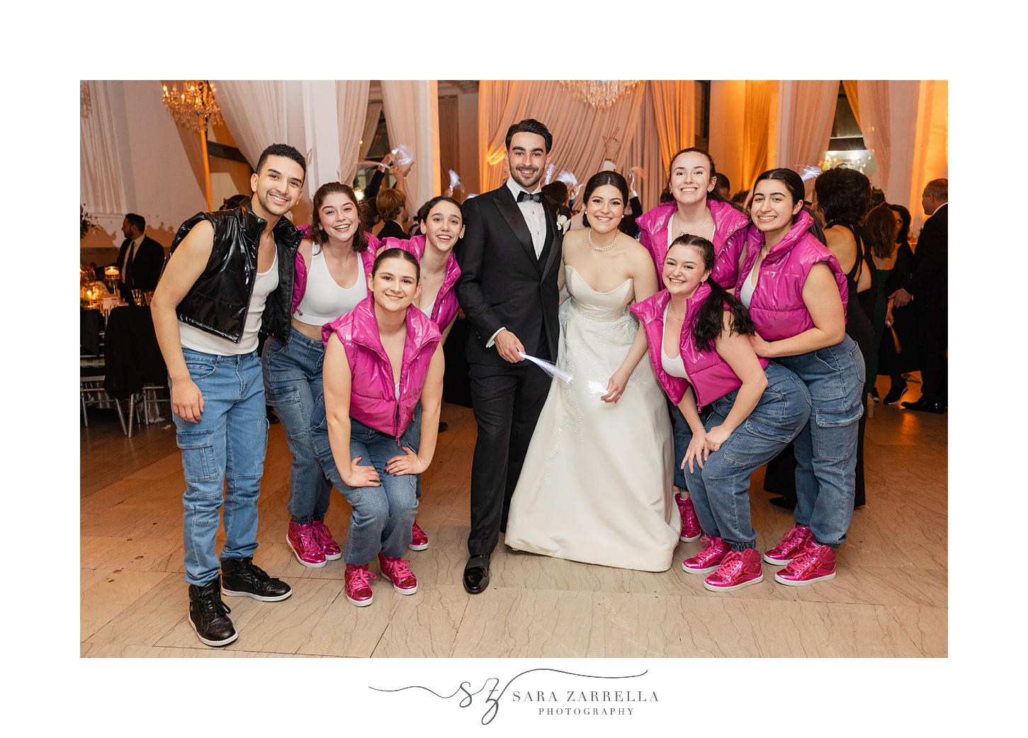 newlyweds pose with dancers during guest performances during RI wedding reception