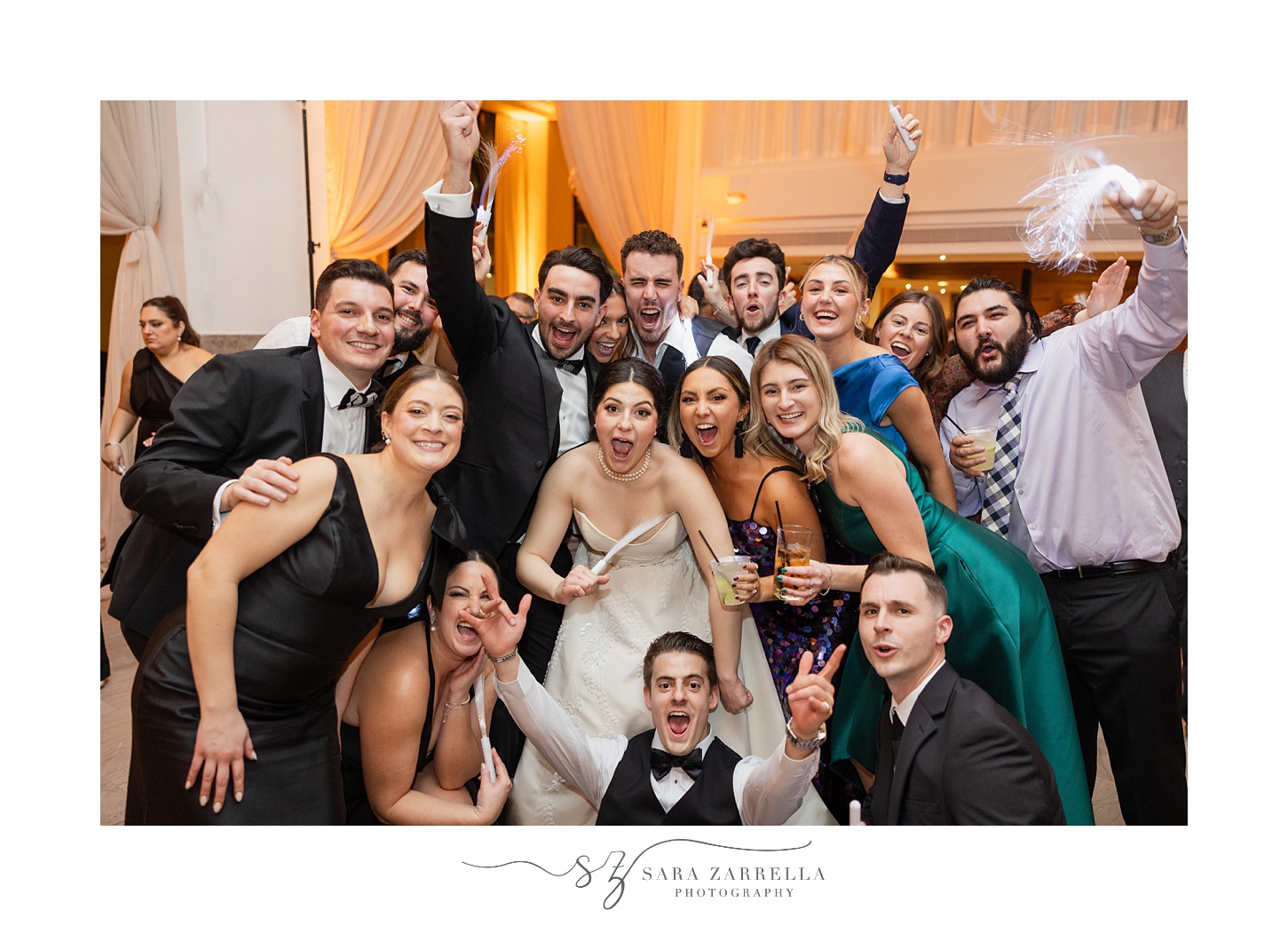 wedding guests pose with newlyweds during Providence RI wedding reception dance floor 