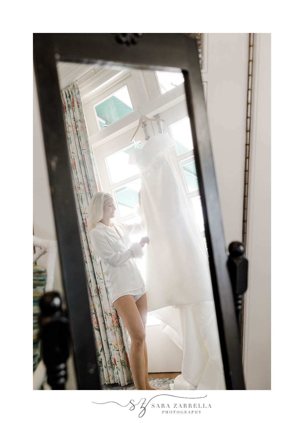 bride looks in mirror during prep for the Dunes Club Wedding