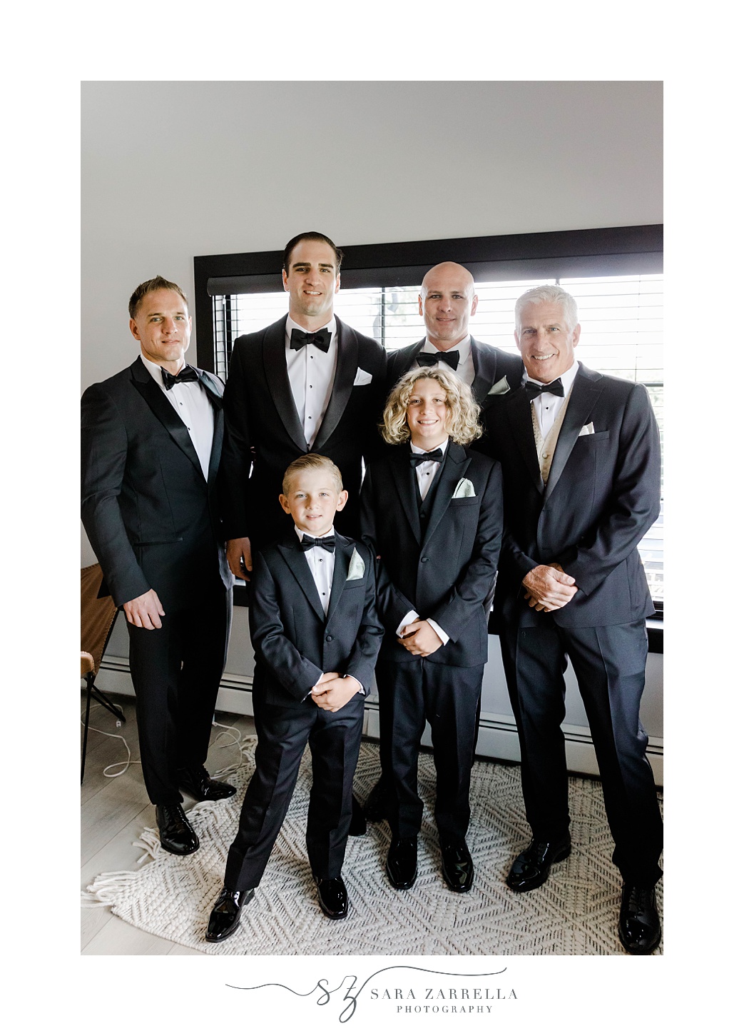 groom stands with groomsmen and ring bearers in Narragansett RI hotel