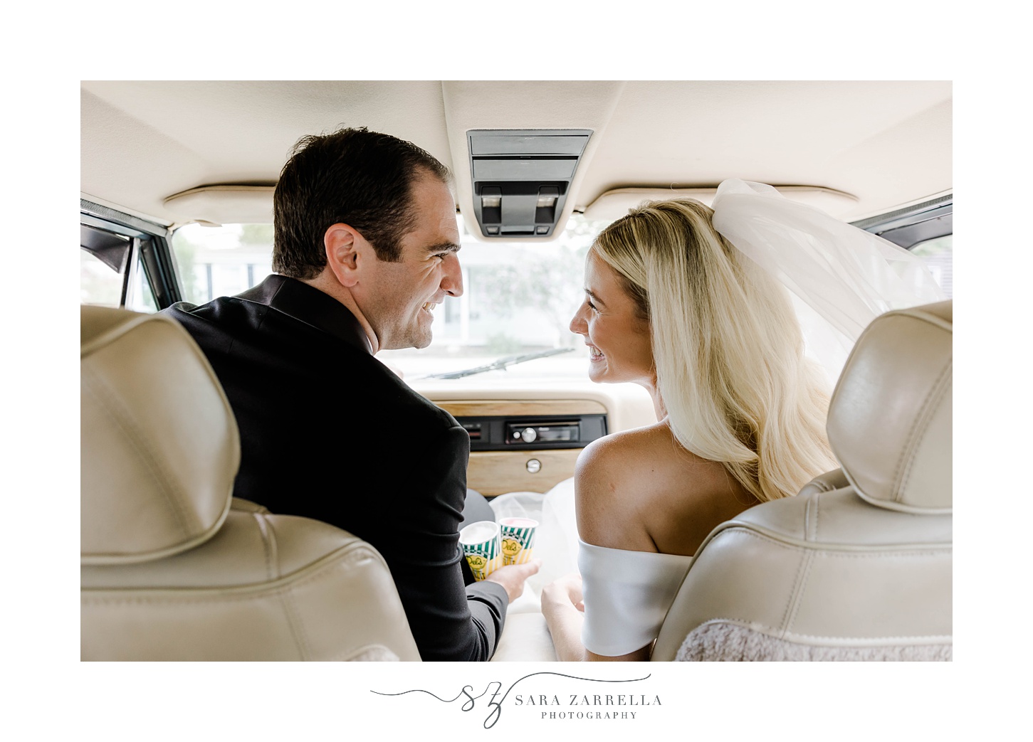 bride and groom sit together inside Grand Jeep Wagoneer
