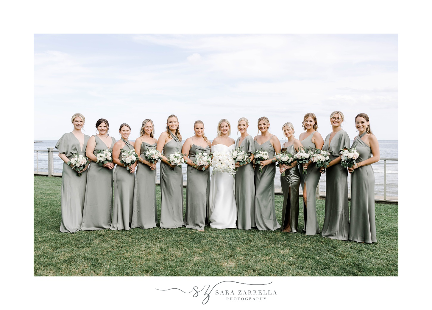 bride poses with bridesmaids in sage green satin gowns 
