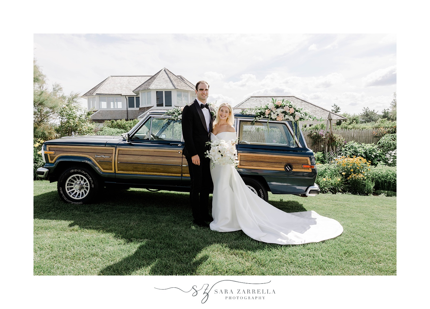 newlyweds stand next to Grand Jeep Wagoneer