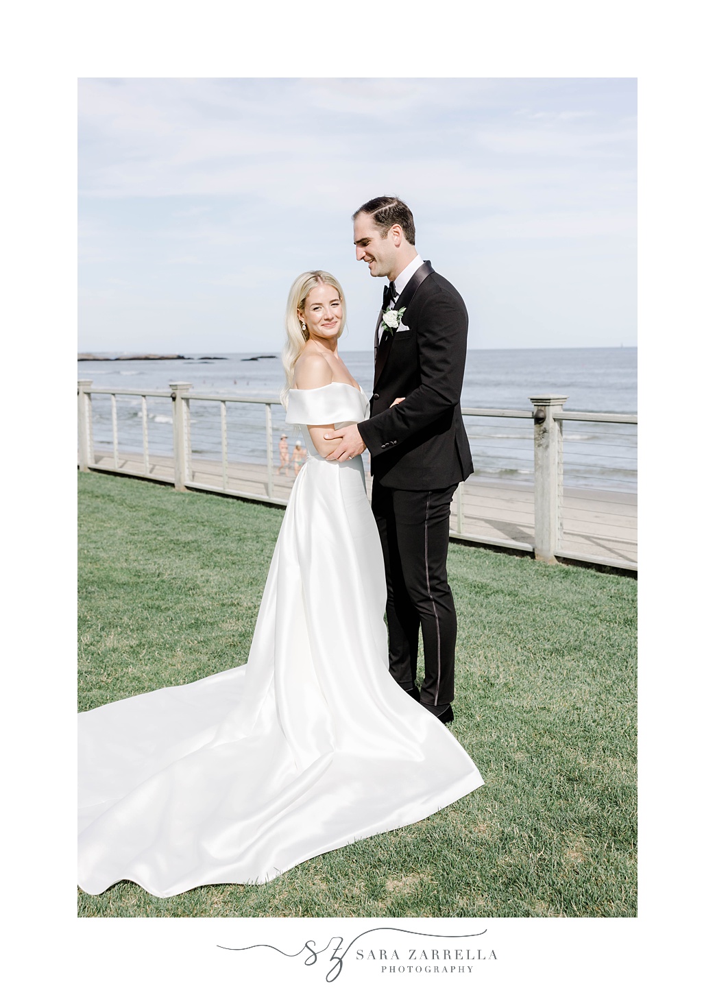 bride and groom hug overlooking Narragansett Bay