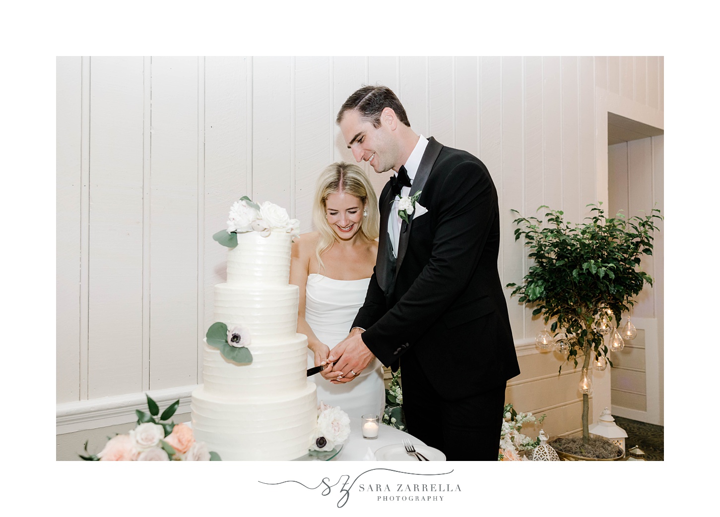bride and groom cut wedding cake during Narragansett, RI wedding reception