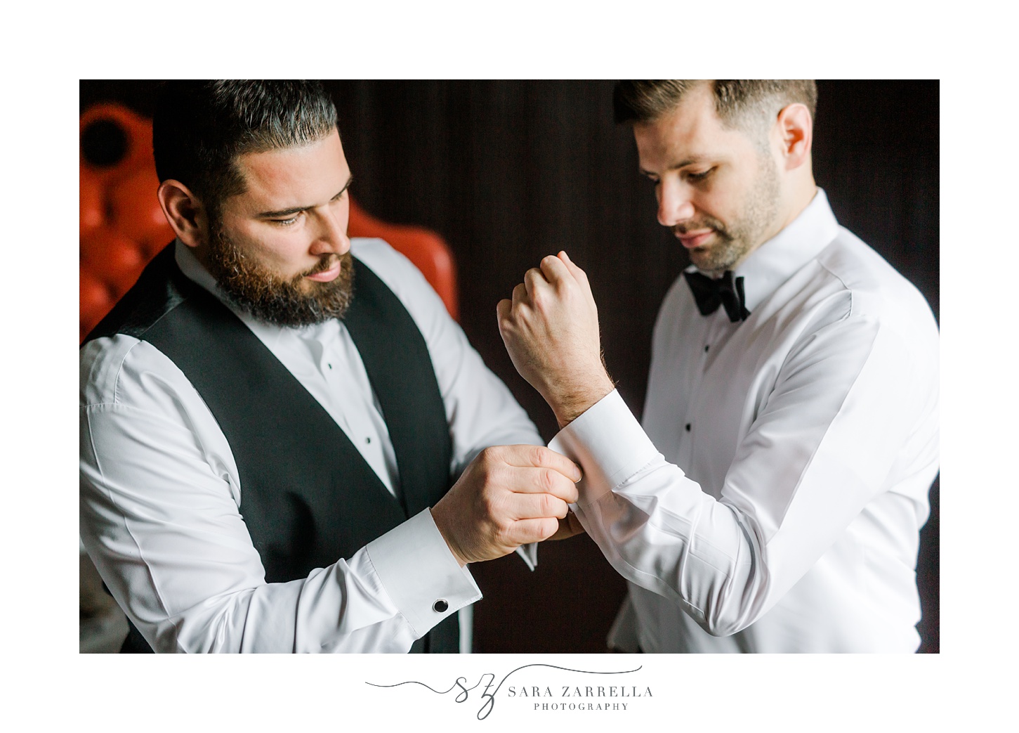 groomsman adjusts cufflinks for groom before New Year's Eve wedding
