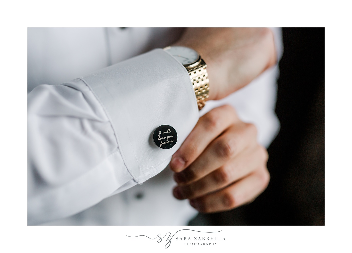 groom shows off custom cufflinks during prep for New Year's Eve wedding