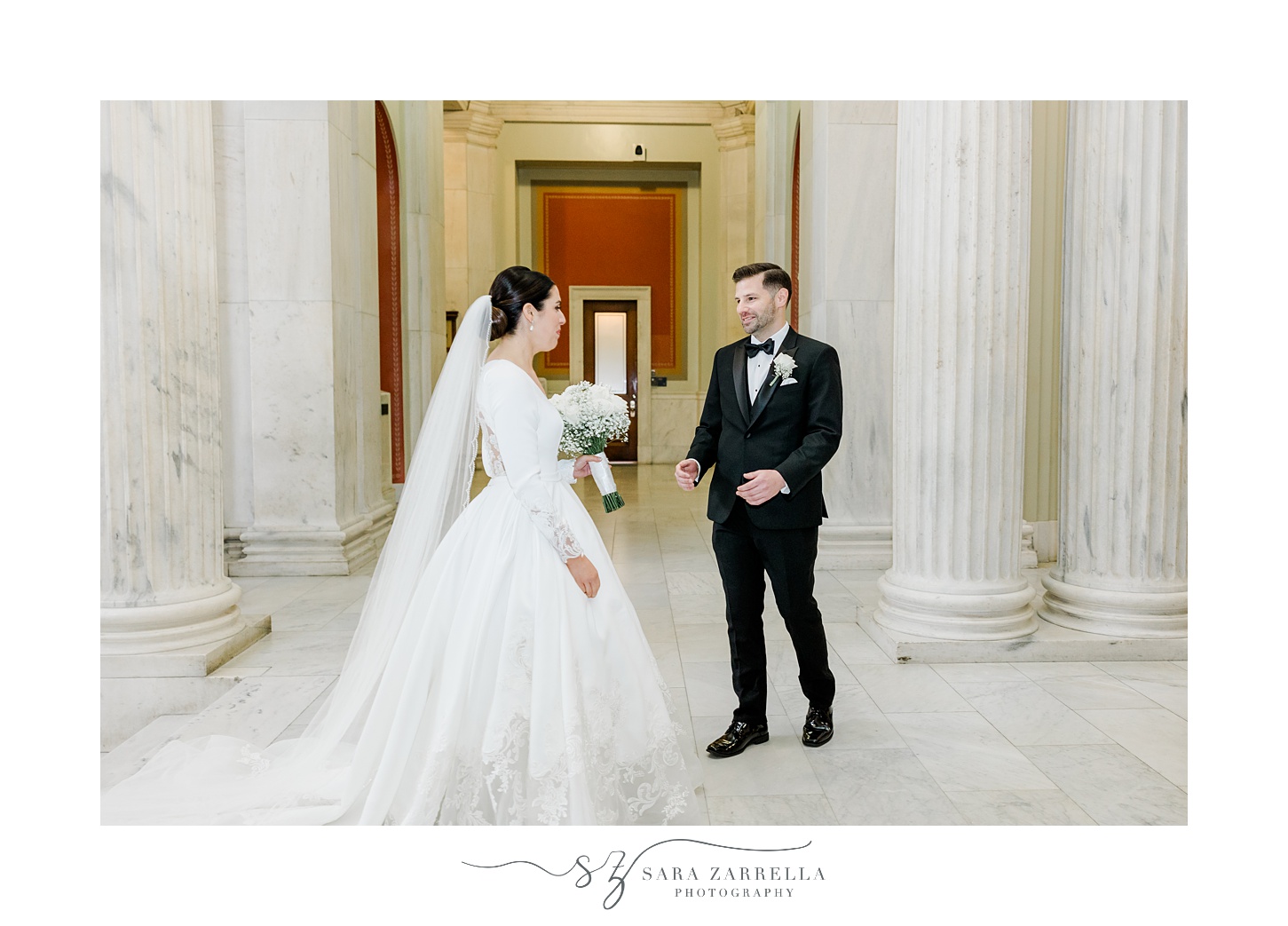 groom turns to look at bride during first look inside the Rhode Island State House