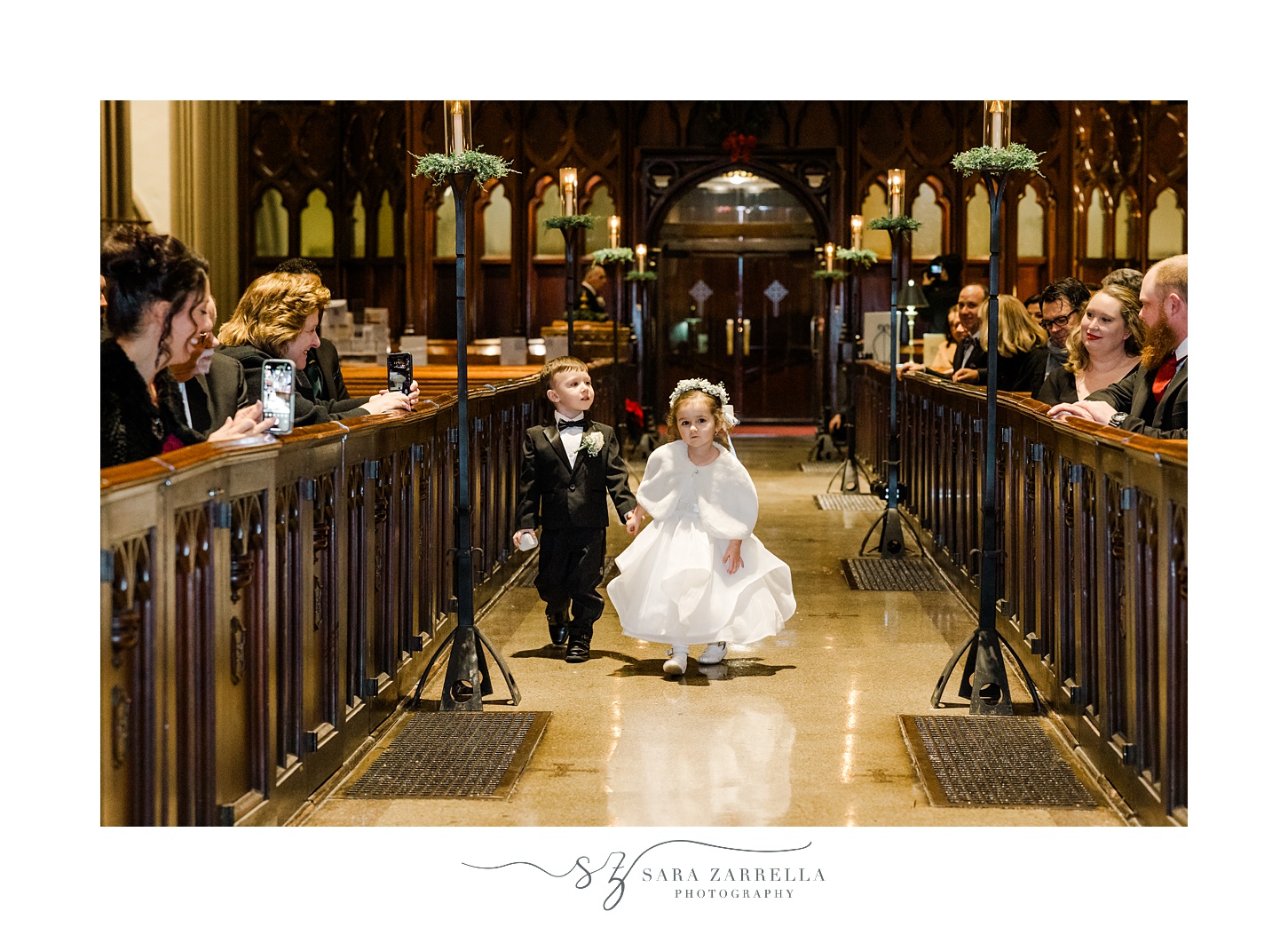 flower girl and ring bearer walks down aisle for traditional church wedding in Providence RI