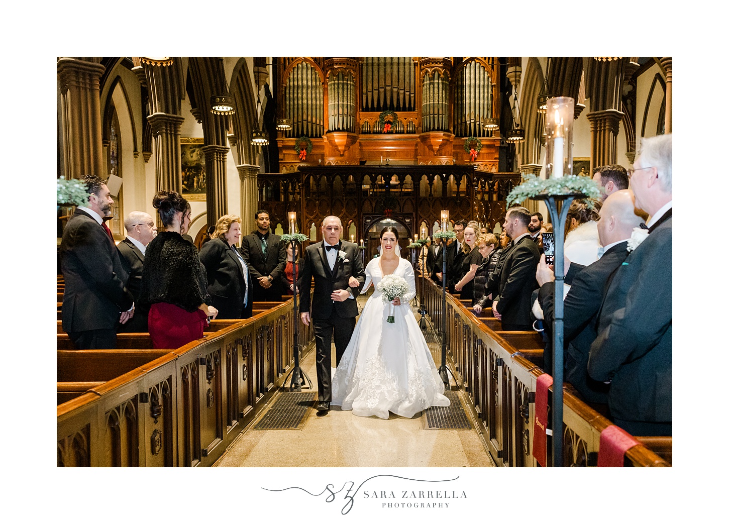 bride walks down aisle with father during traditional church wedding in Providence RI