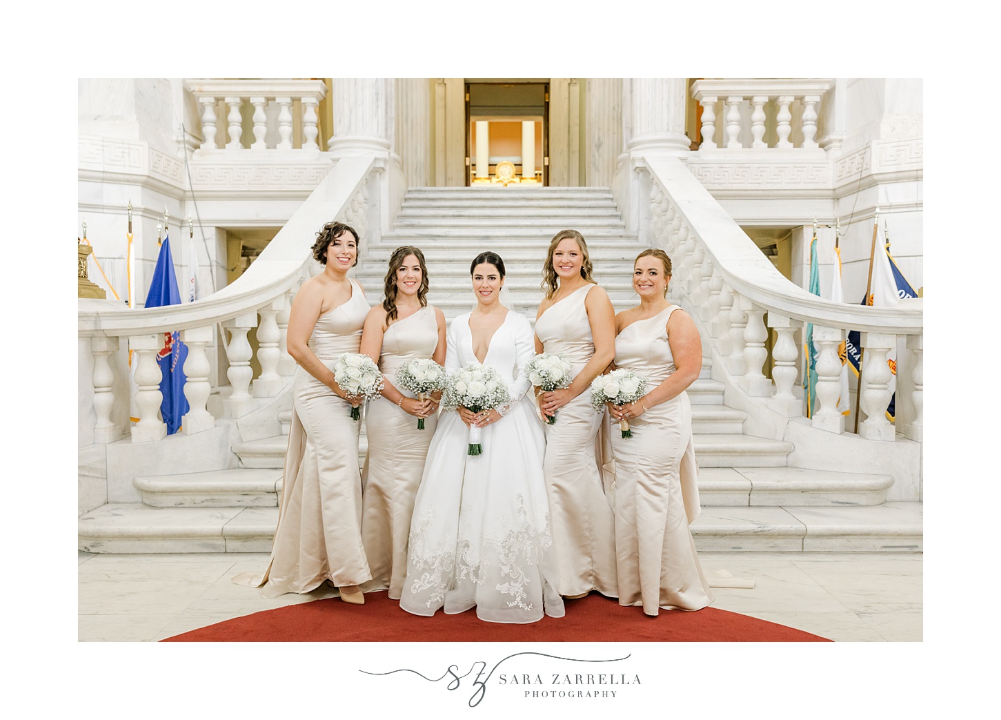 bride stands with bridesmaids in ivory gowns inside the Rhode Island State House in Providence RI