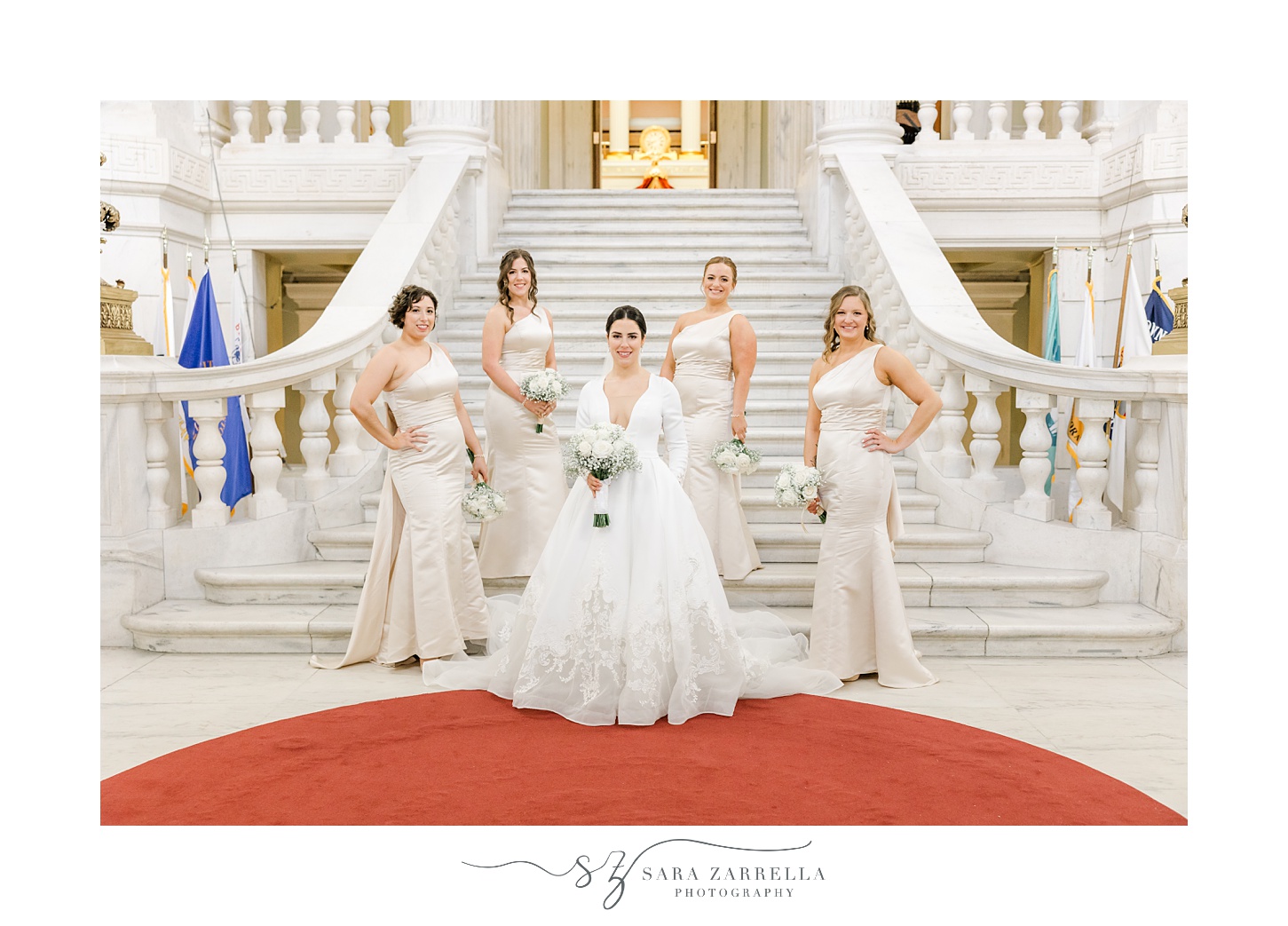 bride and bridesmaids pose on steps inside the Rhode Island State House in Providence RI