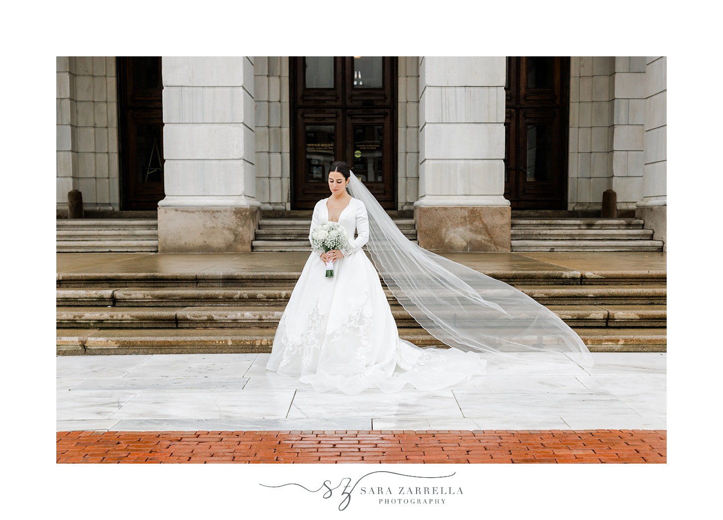 bride holds bouquet with white rose and baby's breath outside the Rhode Island State House in Providence RI