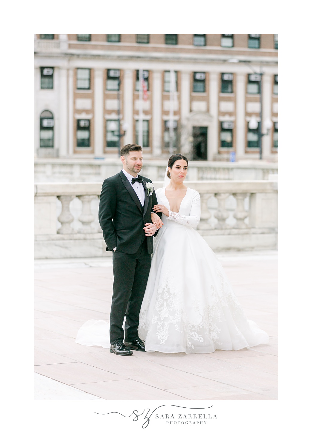 bride holds groom's arm outside the Rhode Island State House in Providence RI