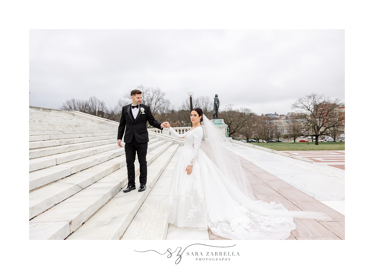 bride and groom walk up staircase at the Rhode Island State House in Providence RI