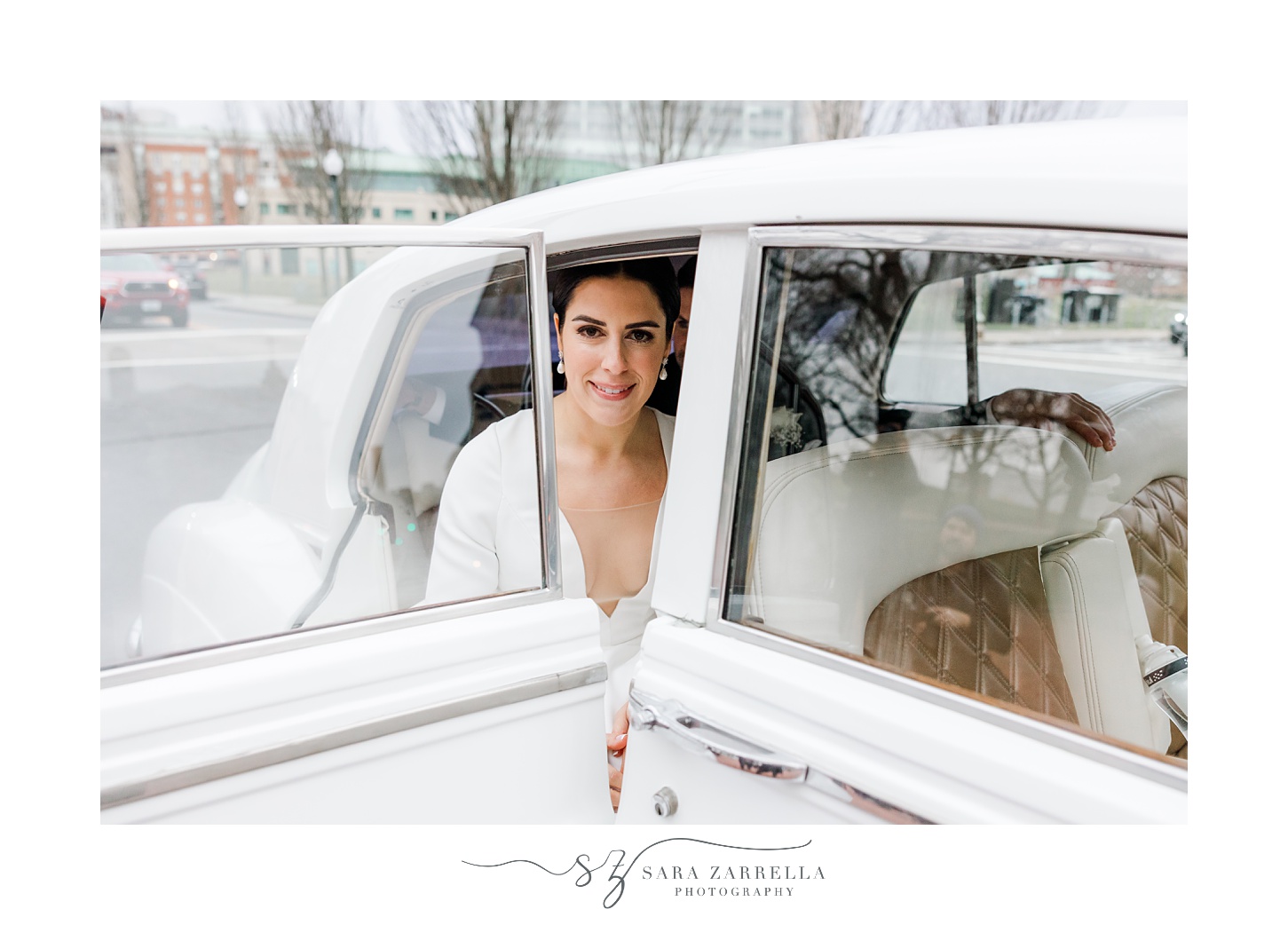 bride sits inside white classic car in Providence RI