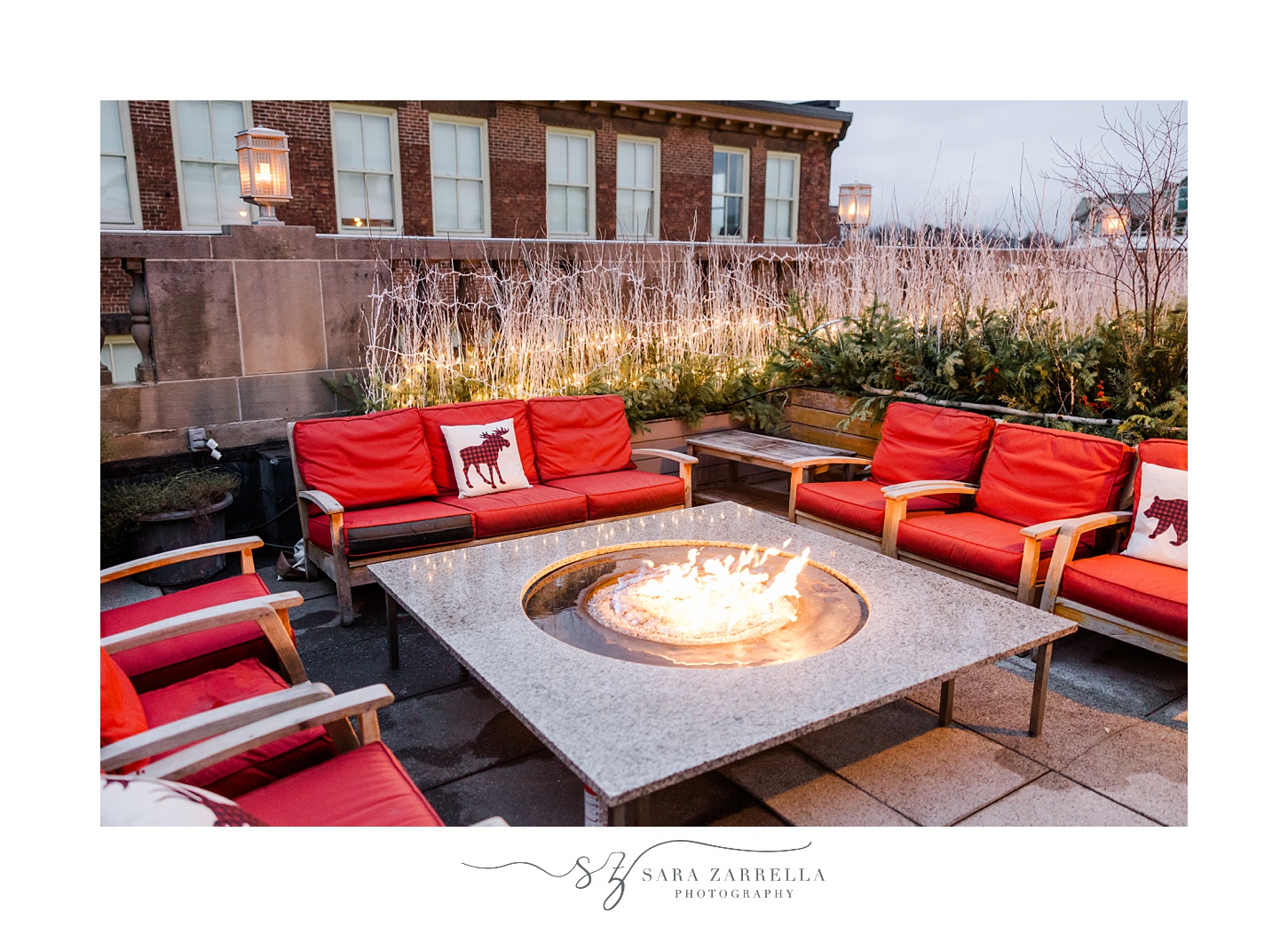 rooftop patio at Providence Gw with red cushions and firepit