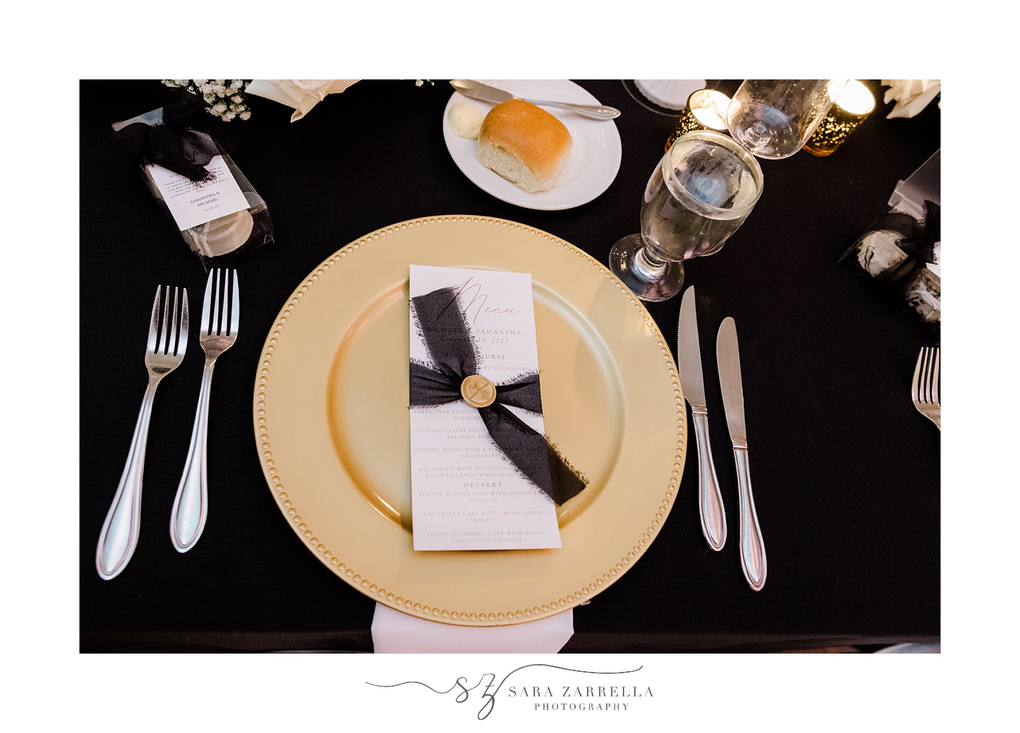 gold plate with black ribbon and wax seal on menu card for New Year's Eve wedding reception at the Providence G