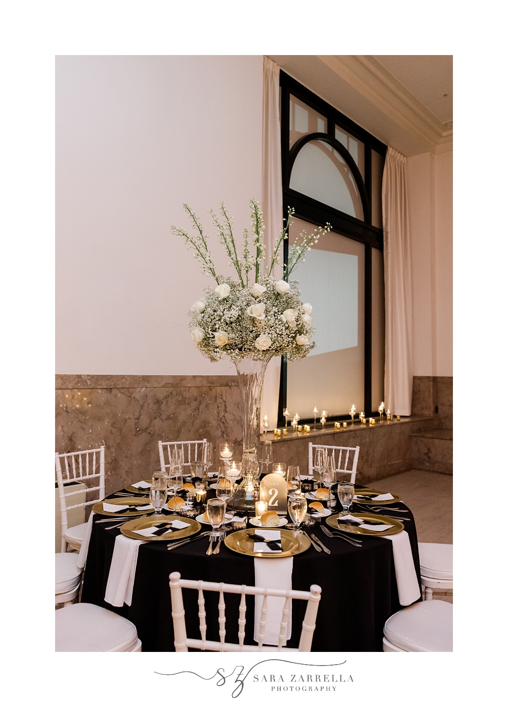 New Year's Eve wedding reception at the Providence G with tall floral centerpiece with white flowers 