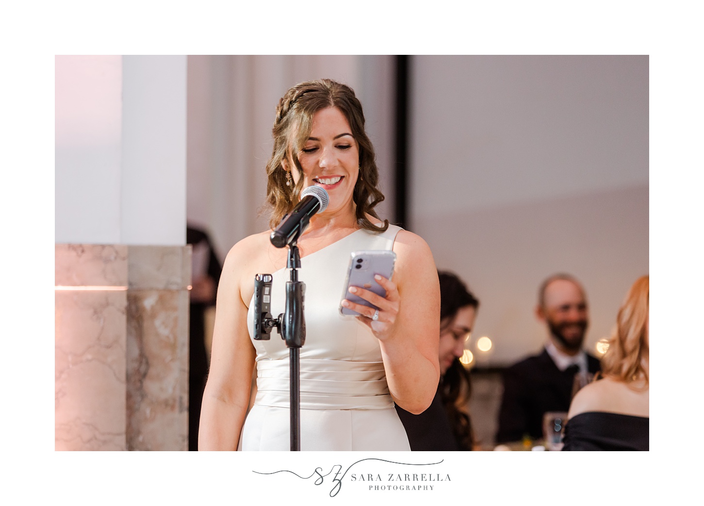 bridesmaid reads speech off phone during New Year's Eve wedding reception at the Providence G
